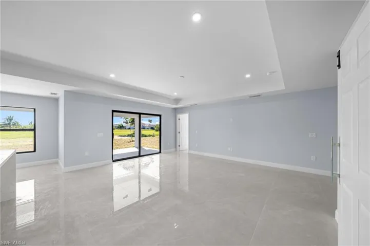 Unfurnished room featuring recessed lighting and a tray ceiling