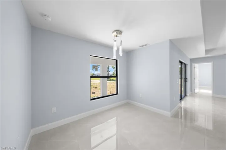 Spare room featuring baseboards and light tile patterned floors