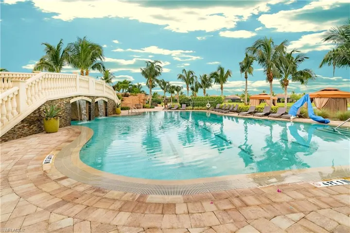 View of swimming pool with pool water feature, a patio, and a water slide