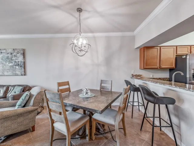 Open floor dining table in living room with a chandelier