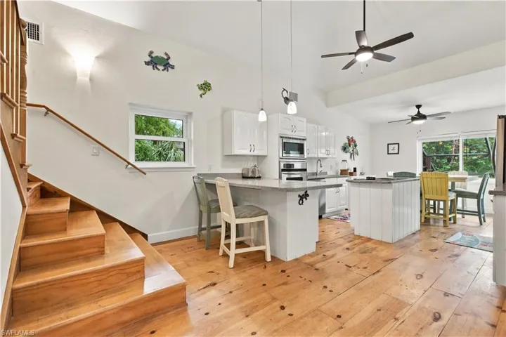Wood-finish flooring throughout, recessed lighting, and a ceiling fan