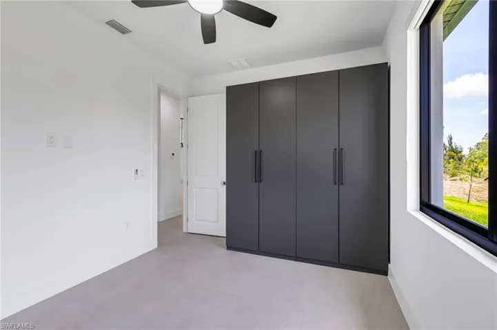 Unfurnished bedroom with baseboards and a ceiling fan