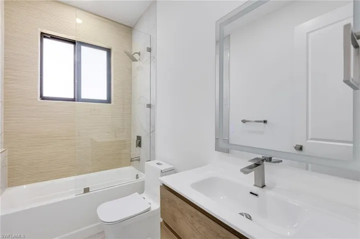 Full bathroom featuring vanity, toilet, and shower / washtub combination