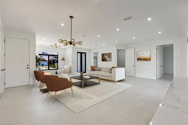 Living room featuring recessed lighting and a chandelier
