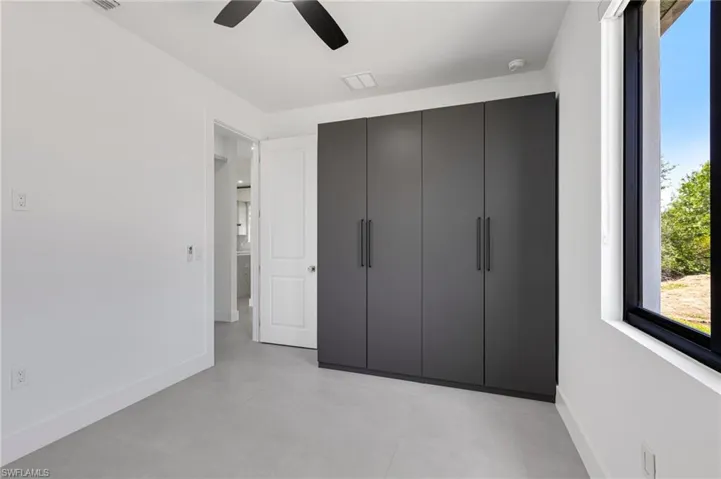 Unfurnished bedroom with baseboards and ceiling fan