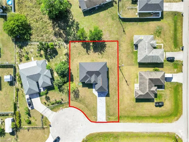Aerial perspective of suburban area featuring property boundaries highlighted
