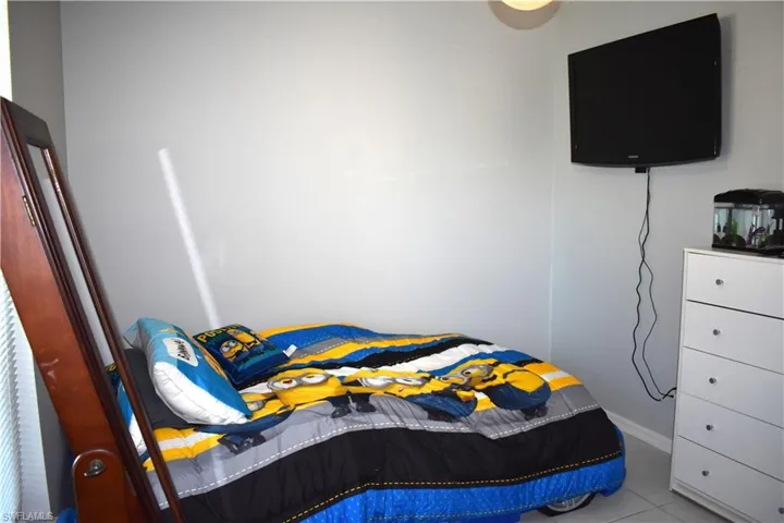 Bedroom featuring light tile flooring