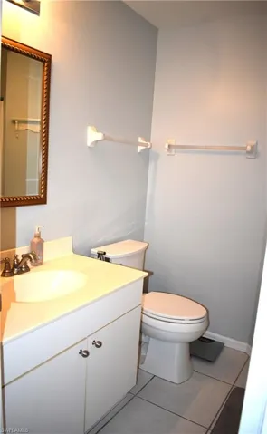 Bathroom featuring tile flooring, oversized vanity, and toilet