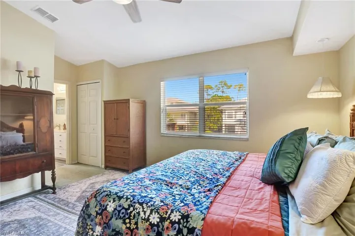 Bedroom featuring ceiling fan, a closet, and carpet flooring