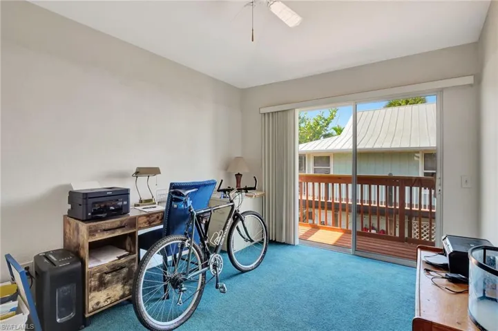 Home office with carpet floors and a ceiling fan