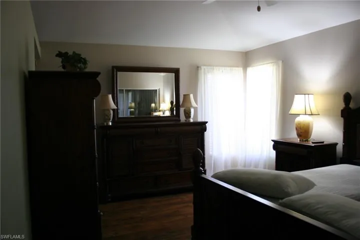 Bedroom with dark wood-style flooring