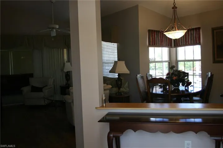 Dining space with a ceiling fan and wood finished floors