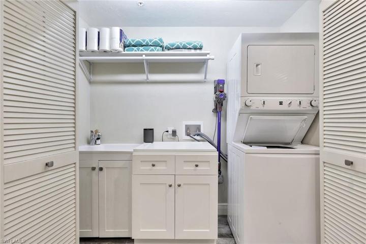 Utility closet located in home with ample storage and folding island