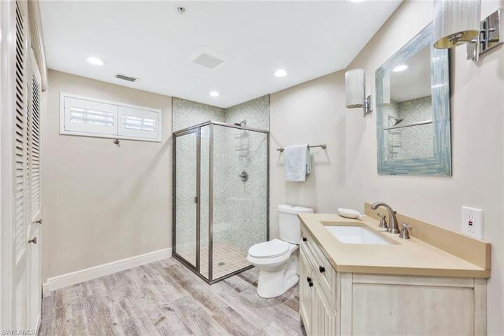 Guest bathroom #2 with walk in shower and designer mirror and light fixtures