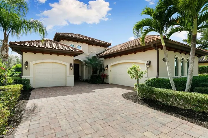 Mediterranean / spanish-style home featuring a garage, stucco siding, decorative driveway, and a tile roof