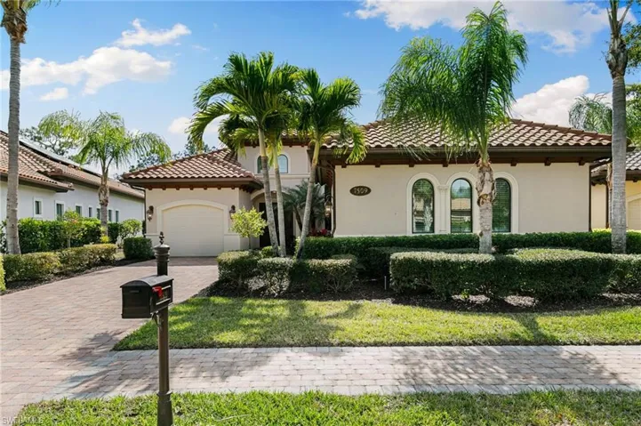 Mediterranean / spanish-style home featuring stucco siding, a tiled roof, an attached garage, and decorative driveway