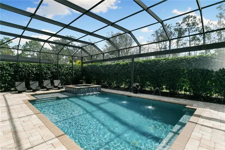 Integrated pool / spa featuring a lanai and a sunroom