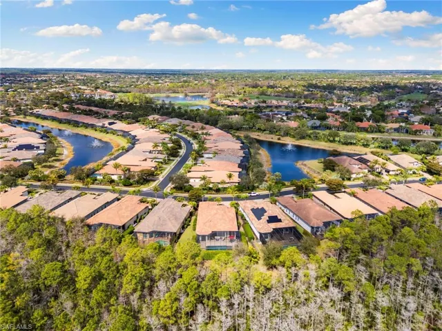 Aerial view of residential area featuring a large body of water