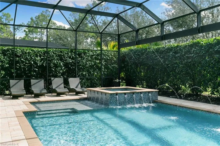 Combined pool / hot tub with glass enclosure and a sunroom