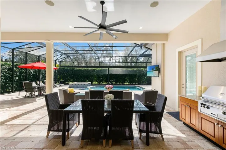 View of patio / terrace with a lanai, a sunroom, and an outdoor kitchen / dining area