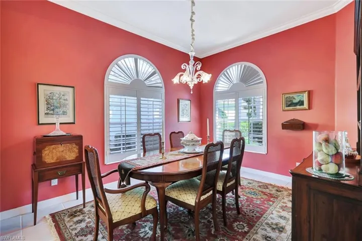 Dining area featuring California Shutters, a notable light fixture, and ornamental molding
