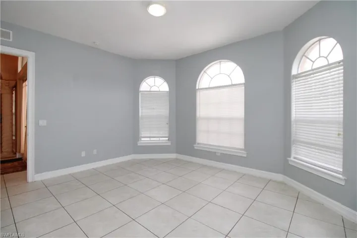 Unfurnished room featuring visible vents and baseboards