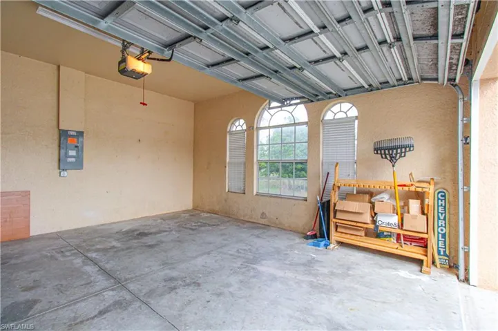Garage with electric panel and a garage door opener
