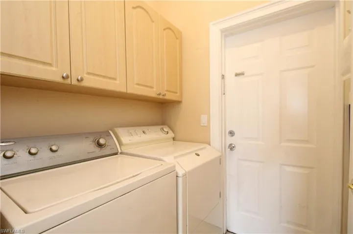 Washroom with cabinet space and washer and dryer