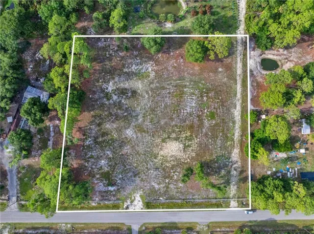 Expansive lot featuring cleared land and partial tree coverage