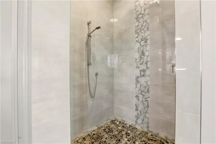 Primary Full bathroom featuring a tile shower with custom listello.