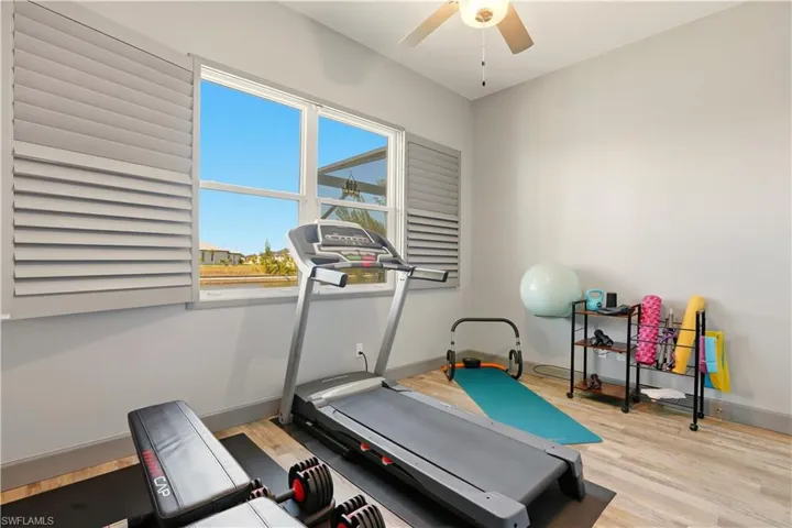 5th Bedroom or Workout area with light wood finished floors and ceiling fan