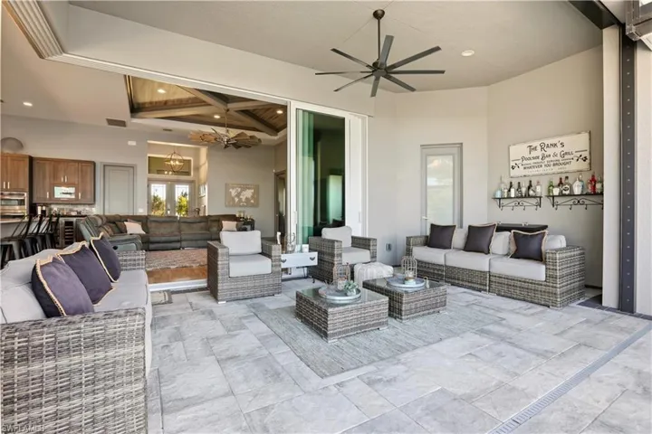 Enjoy the Outdoor Lifestyle out of the sun in this large covered lanai space.  Large stone pavers start in the covered lanai area and extend in their entirety around the pool.