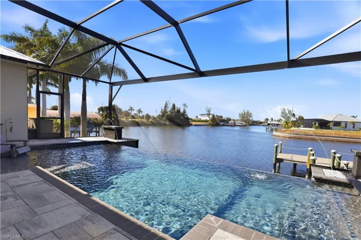 View of Infinity Edge swimming pool from the lanai and a deep water view with DIRECT ACCESS to the GULF with NO BRIDGES!