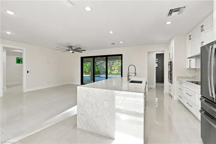 Waterfall island with an undermount sink and modern faucet