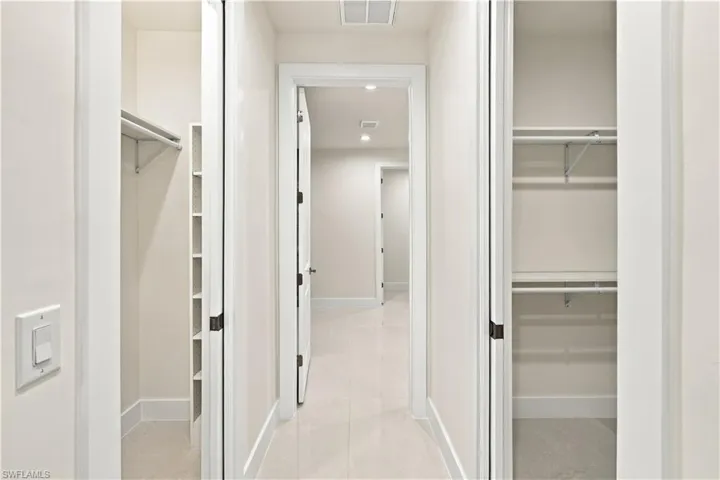 Hallway featuring recessed lighting, light-toned walls, and a light tile floor