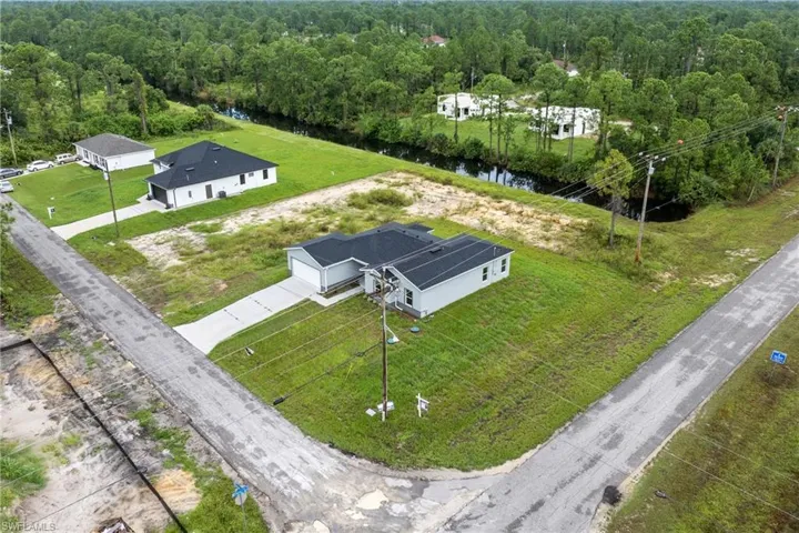 Aerial perspective of suburban area featuring a forest