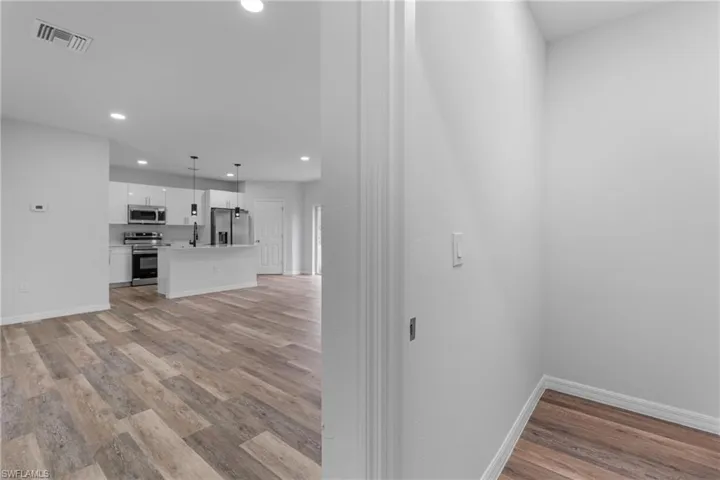Unfurnished living room with light wood-style floors and recessed lighting
