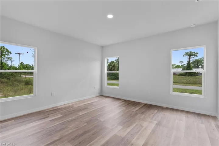 Empty room with recessed lighting, healthy amount of natural light, and light wood finished floors
