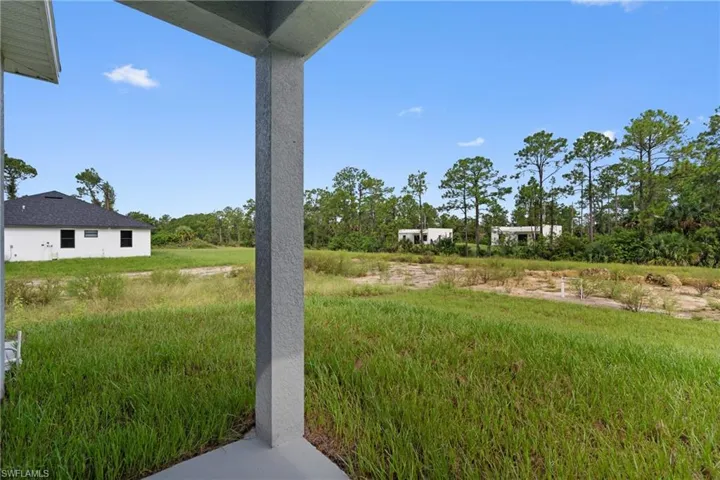 View of yard featuring a patio area and view of wooded area