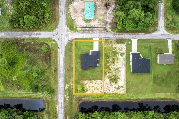 Aerial overview of property's location with property parcel outlined and a large body of water