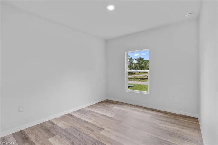 Unfurnished room with light wood finished floors and recessed lighting
