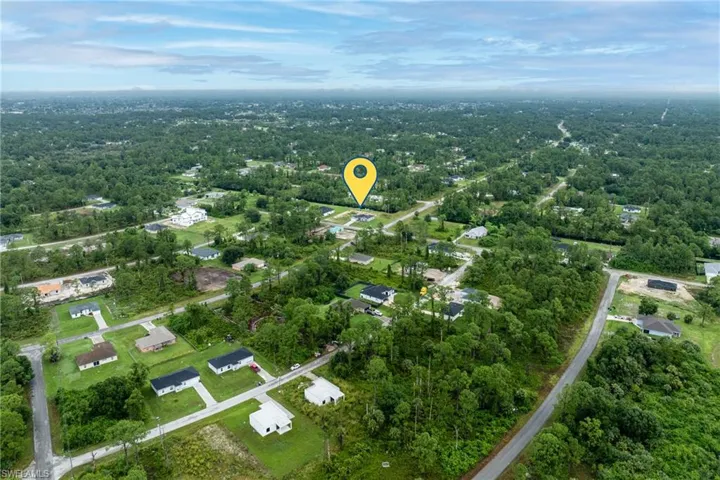 View of property location with nearby suburban area
