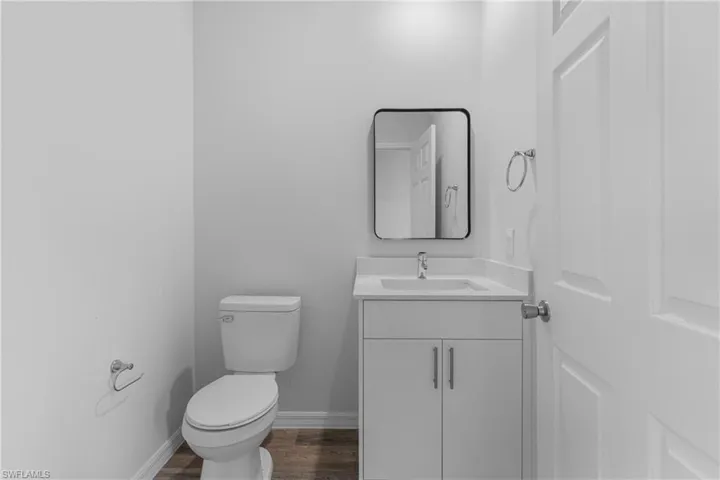 Bathroom featuring vanity and dark wood-style flooring