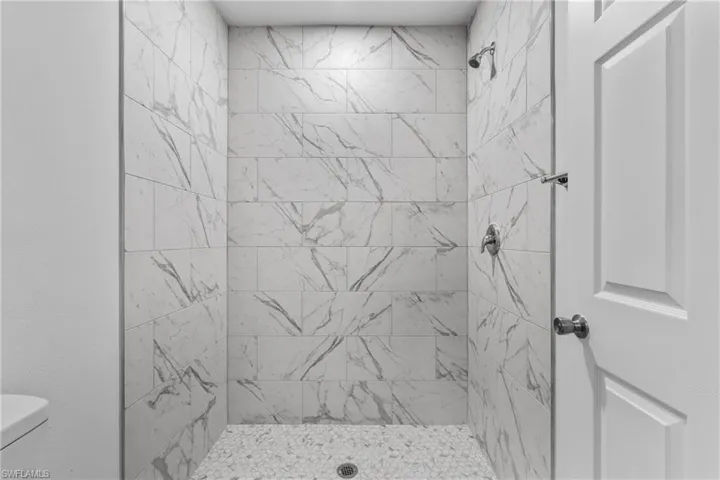 Full bath with toilet and a stall shower