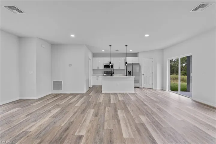Unfurnished living room featuring light wood-style floors and recessed lighting