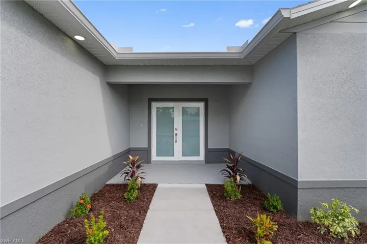 Property entrance featuring french doors and stucco siding