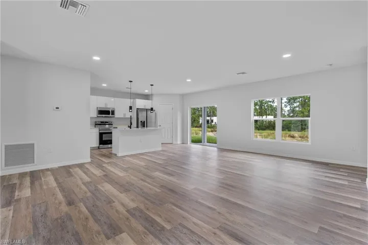 Unfurnished living room featuring light wood-style floors and recessed lighting