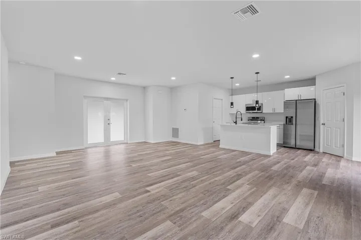 Unfurnished living room featuring light wood-style flooring and recessed lighting