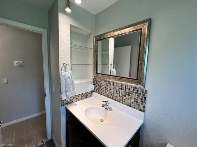 Bathroom featuring tile floors, tasteful backsplash, and oversized vanity
