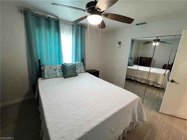 Bedroom featuring hardwood / wood-style flooring, a closet, and ceiling fan